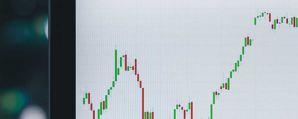 Ticker graph on laptop representing stock market