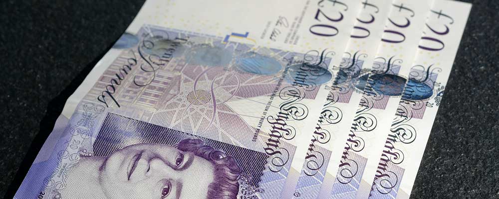 £20 notes lying on table to depict UK pension transfer values