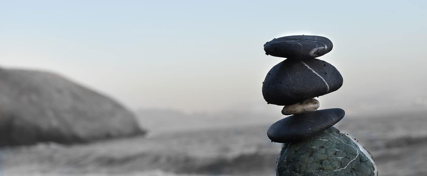 Stones balanced on top of each other representing balance in the post